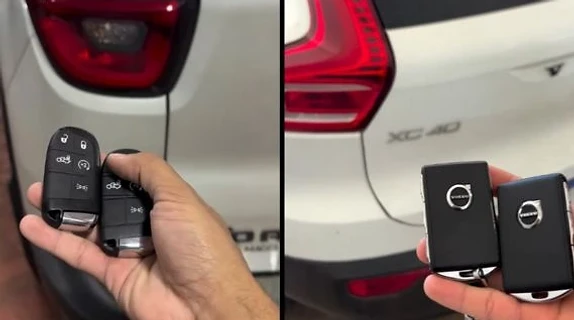 Chaves automotivas em mãos ao lado de veículos brancos